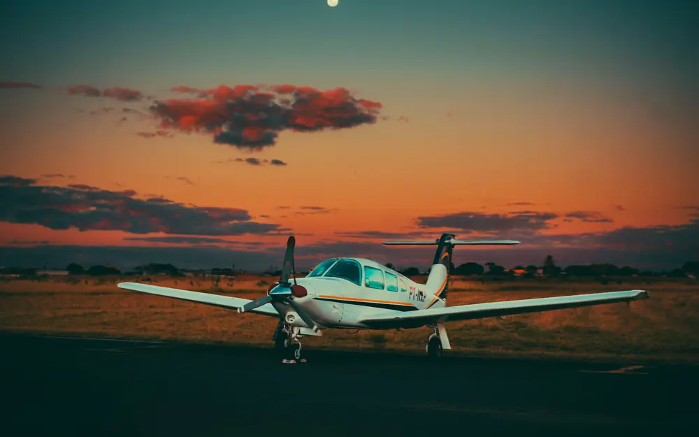 Piper on the ramp at dusk under a sunset sky